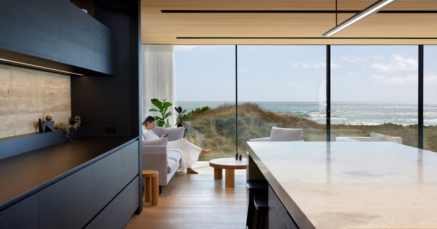 Woman relaxing in architecturally designed home